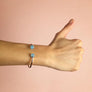 Xtinctio - Bangle Sterling Silver dipped Platinum and Blue Chalcedony stone. Imbued with the spirit of the Ocean and serving as a constant reminder that in this age of extinction, we are all connected to every living thing. Our partner in Ocean Conservation is The Coral Reef Restoration.