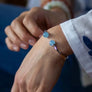 Xtinctio - Bangle Sterling Silver dipped Platinum and Blue Chalcedony stone. Imbued with the spirit of the Ocean and serving as a constant reminder that in this age of extinction, we are all connected to every living thing. Our partner in Ocean Conservation is The Coral Reef Restoration.